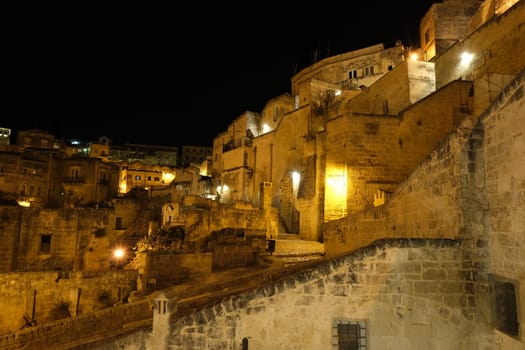Night lights of the city of Matera. Streets and houses lit by traditional yellow street lamps with sodium vapors.