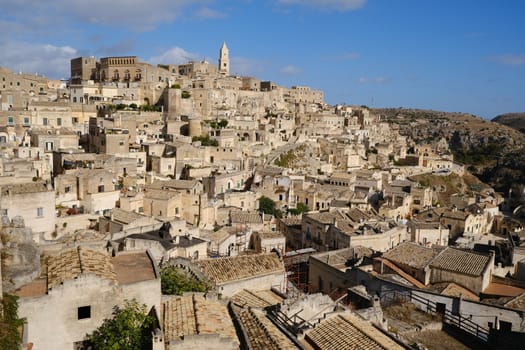 Panorama of houses and of the Sassi of Matera with roofs and streets. Blue sky with 