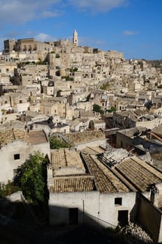 Panorama of houses and of the Sassi of Matera with roofs and streets. Blue sky with 