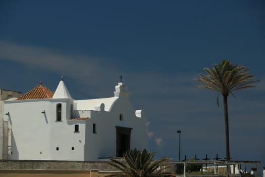 Church of Soccorso in Forio on the island of Ischia near Naples. Example of typical Mediterranean architecture rises above the sea.