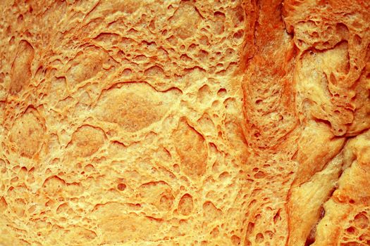 Extreme closeup of loaf of wheat bread as background