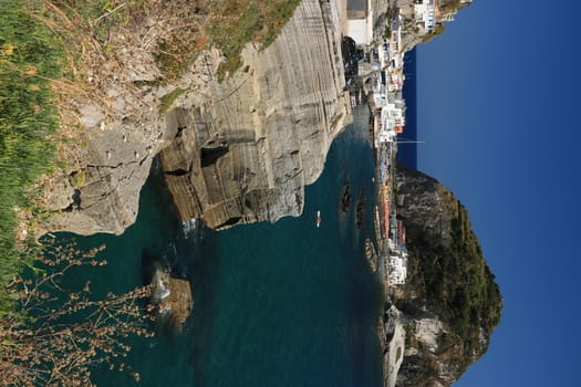 Sant'angelo di Ischia, Mediterranean sea near Naples. The mountain is connected to the mainland by a sandy beach with umbrellas.