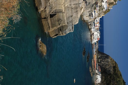 Sant'angelo di Ischia, Mediterranean sea near Naples. The mountain is connected to the mainland by a sandy beach with umbrellas.