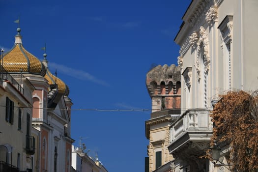 Oriental style dome and buildings with floral decorations on the island of Ischia. Blue sky.