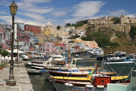 Procida island, Naples, Italy, About the July 2019. Village of Marina Corricella, Procida Island, Mediterranean Sea, near Naples. Colorful houses in the fishing village and boats anchored in the harbor.