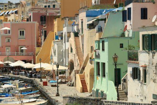 Procida island, Naples, Italy, About the July 2019. Boats anchored in the port of Corricella on the Island of Procida. Typical colorful Mediterranean style houses and fishing boats in the harbor.