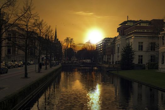 Sunset on the royal horse stale along a calm canal at the Maritskade street in The Hague, Netherlands