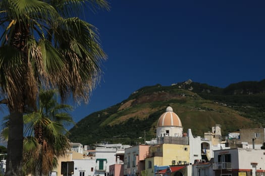 Panorama of the town of Forio d'Ischia, near Naples. 	Dome of the church of San Gaetano. The mountain and the blue sky.
