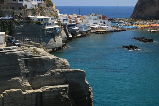 Sant'angelo di Ischia, Mediterranean sea near Naples. The mountain is connected to the mainland by a sandy beach with umbrellas.