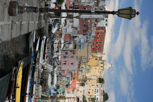 Procida island, Naples, Italy, About the July 2019. Village of Marina Corricella, Procida Island, Mediterranean Sea, near Naples. Colorful houses in the fishing village and boats anchored in the harbor.