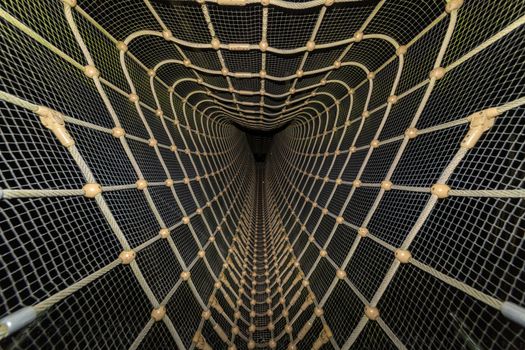 Getting through an outdoor playground with hanging bridge and net at night