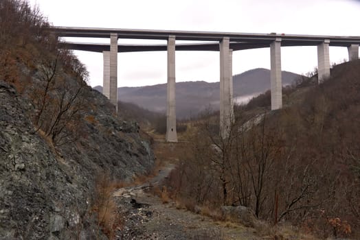 Highway of the Cisa. Asphalt strip running through the mountains of Tuscany and Emilia. Bridge with high pillars in reinforced concrete.