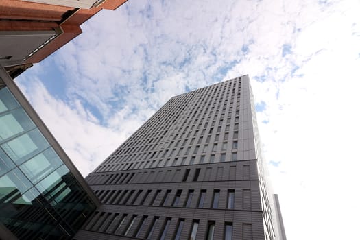  Modern buildings of the new Berlin. The sky is mirrored in a window