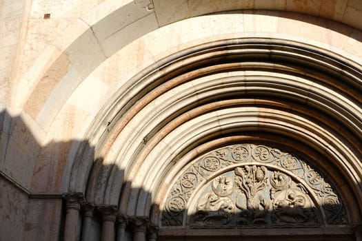 Marble portal of the baptistery of Parma. The building has an external façade built in red Verona marble.