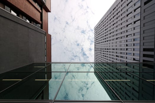 Modern buildings of the new Berlin. The sky is mirrored in a window