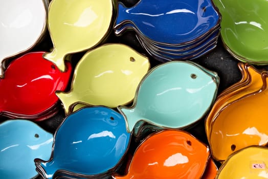 Handmade ceramic decorations representing colorful fish.