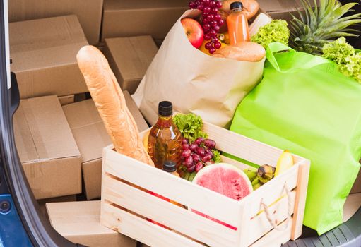 Grocery service giving fresh vegetables and fruits and food in green cloth bag and wooden basket on the back car ready delivery to send woman customer