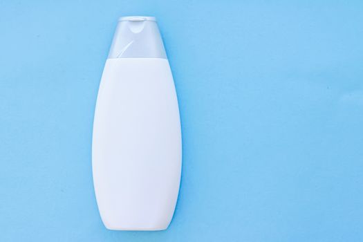 Blank label cosmetic container bottle as product mockup on blue background, hygiene and healthcare