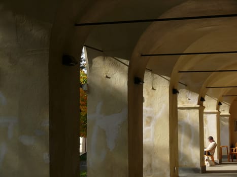 Cinqueterre, La Spezia, Italy. About 10/2015. Porch with arches and a person sitting to rest.