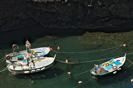 Fishing boats in the harbor. View from above. In the village of Framura, near the Cinque Terre a blue sea and dreamlike landscapes.