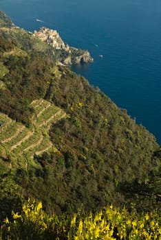 Corniglia to the Cinque Terre. Seascape at sunset time. A fog rises from the sea and creates a magical atmosphere.