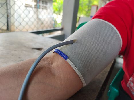 close-up asian fat woman measuring hypertension blood pressure