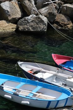 Colored boats on the blue sea. Riomaggiore, Cinque Terre. Royalty Free Stock Photos.