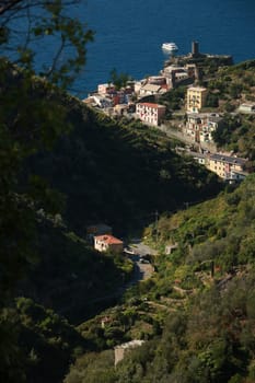 Vernazza village seen from the path that goes up the hill to the Cinque Terre. Castle with the cylindrical tower.