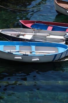 Colored boats on the blue sea. Riomaggiore, Cinque Terre. Royalty Free Stock Photos.