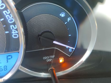 Fuel gauge showing empty tank with yellow glowing and lit meter