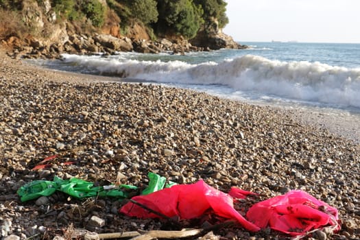Plastic waste deposited from the sea on the beach after the storm. Liguria, Italy.