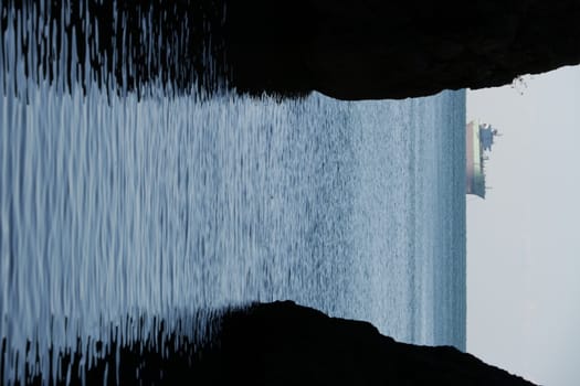 Oil tanker In the middle of the sea between two rocks.