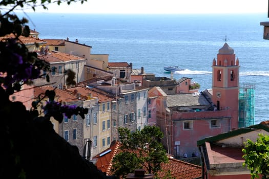 Village of Tellaro di Lerici near the Cinque Terre. Top view with the church bell tower, the houses and the sea.