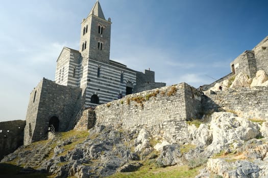 Portovenere, Liguria, Italy. About 10/ 2019. Church of San Pietro in Portovenere, near the Cinque Terre. Stairway with tourists visiting the Ligurian fishing village.