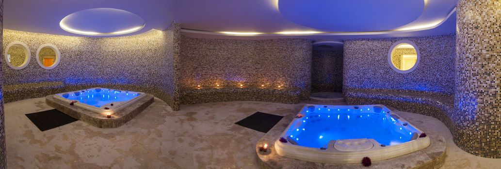 Panoramic view of wet area in a luxury health spa with two large jacuzzi