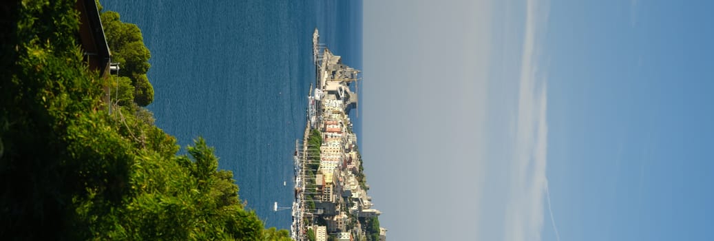 Panorama from the top of Portovenere, near the Cinque Terre, at sunrise light. The bay with the marina, the fort, the church of San Pietro. La Spezia