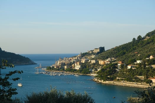 Panorama from the top of Portovenere, near the Cinque Terre, at sunrise light. The bay with the marina, the fort, the church of San Pietro. La Spezia