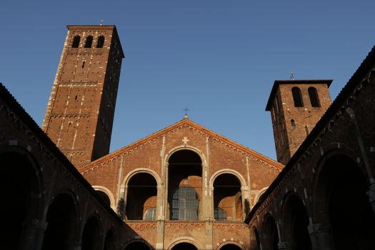 Detail of the facade of the church of Sant'Ambrogio in Milan built with red bricks.