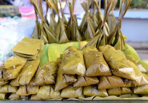 Steamed sticky rice with banana, Thai street food.