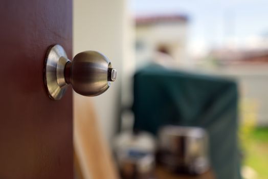Stainless steel doorknob on a blurry background