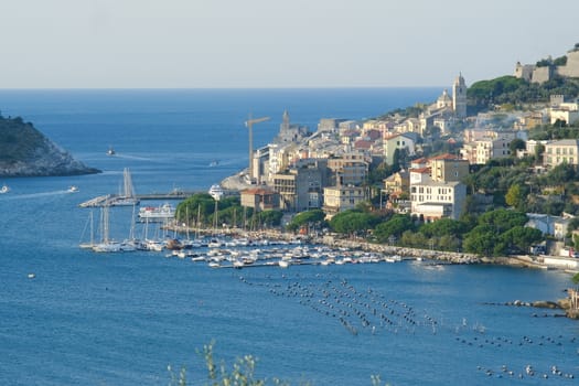 Panorama from the top of Portovenere, near the Cinque Terre, at sunrise light. The bay with the marina, the fort, the church of San Pietro. La Spezia