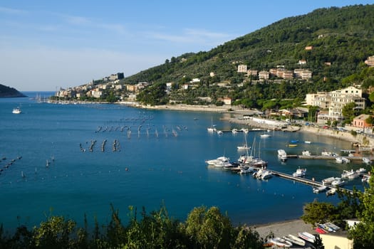 Portovenere, Liguria, Italy. About 10/ 2019. Panorama from the top of Portovenere, near the Cinque Terre at sunrise light. The bay with the mussel farm, the fort, the church of San Pietro.