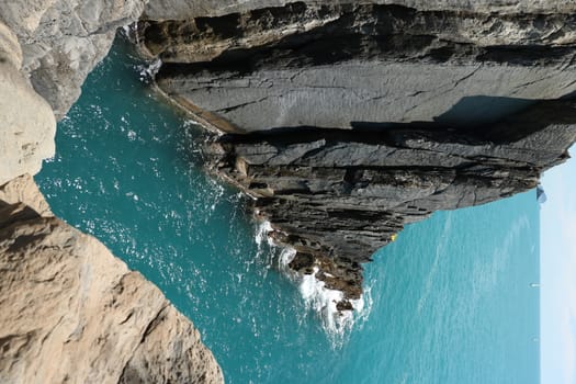 Cliff with rocks that plunge into the blue sea of the Cinque Terre.