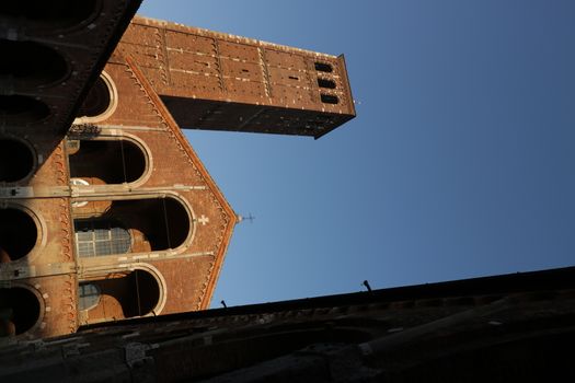 Detail of the facade of the church of Sant'Ambrogio in Milan built with red bricks.