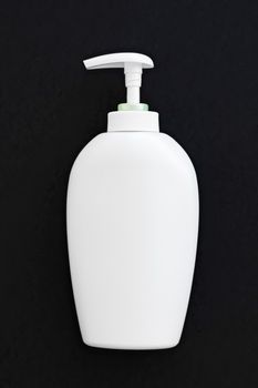 Blank label cosmetic container bottle as product mockup on black background, hygiene and healthcare