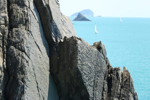 Cliff with rocks that plunge into the blue sea of the Cinque Terre.