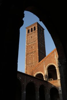 Detail of the facade of the church of Sant'Ambrogio in Milan built with red bricks.
