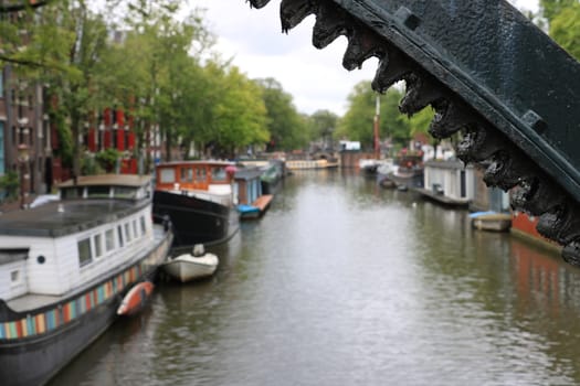 Amsterdam, Netherlands. About the July 2019. Houseboats and boats in an Amsterdam canal. Boats converted into dwellings anchored on the city canals.