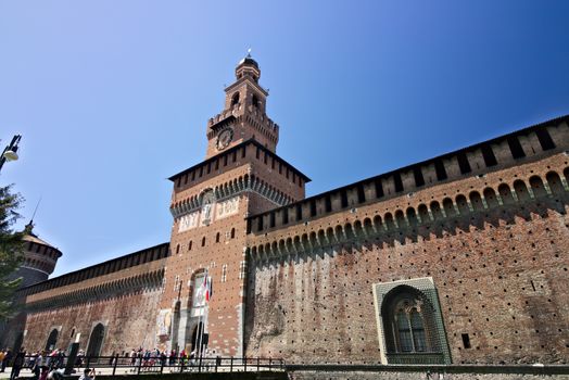 Milan, Lombardy, Italy, 04/27/2019. Sforza Castle. Tower with clock. The tower that overlooks the entrance to the walls of the castle of Milano. 