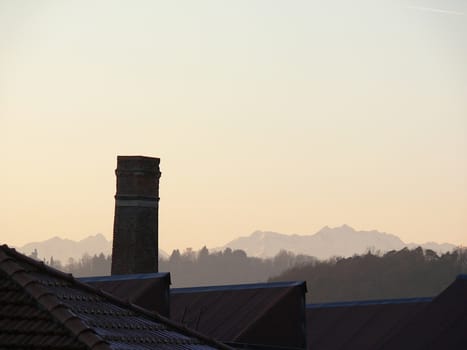 Work of industrial archaeology. In the background the profile of the mountains (Alps)